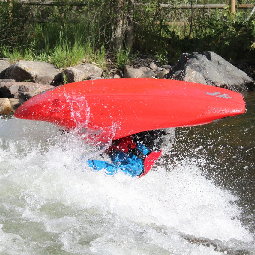 Timothy Kunin executes a flipping maneuver during the June 22 Kayak Rodeo at Clear Creek Whitewater Park.